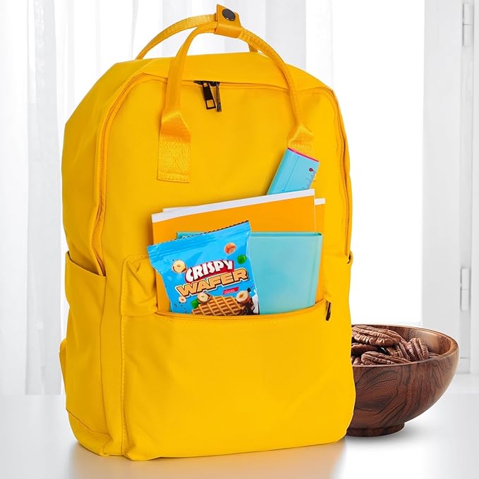 Yellow backpack with snacks and a bowl on a white background