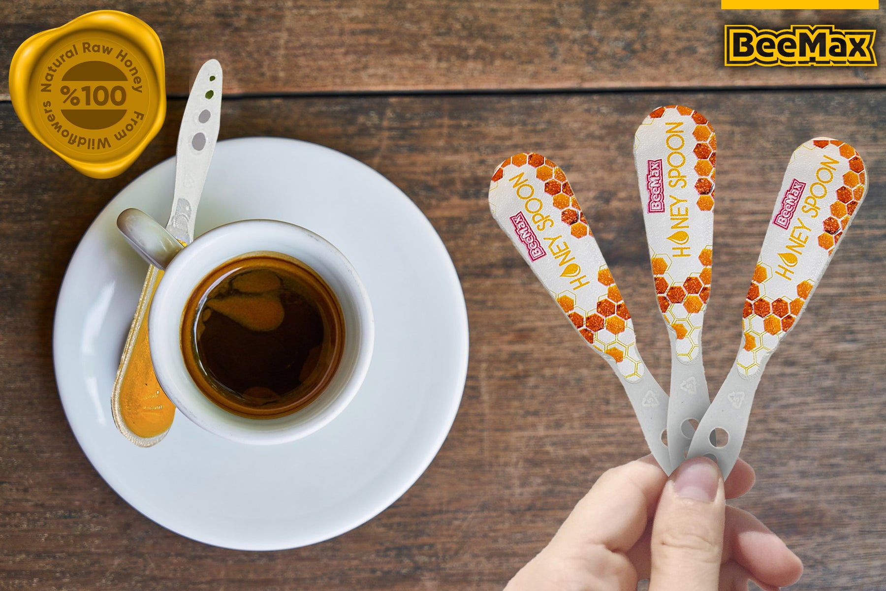 BeeMax honey spoons with a cup of coffee on a wooden surface